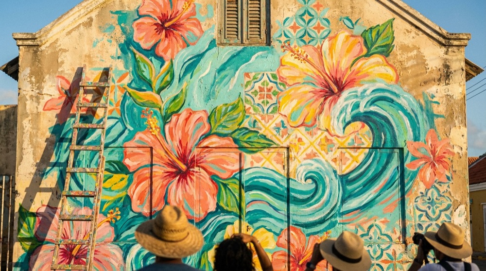 Colorful tropical mural covering a San Nicolas facade