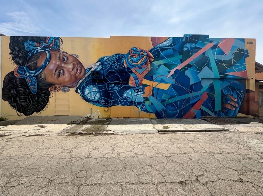 Giant mural of a sleeping woman in blue patterns, San Nicolas